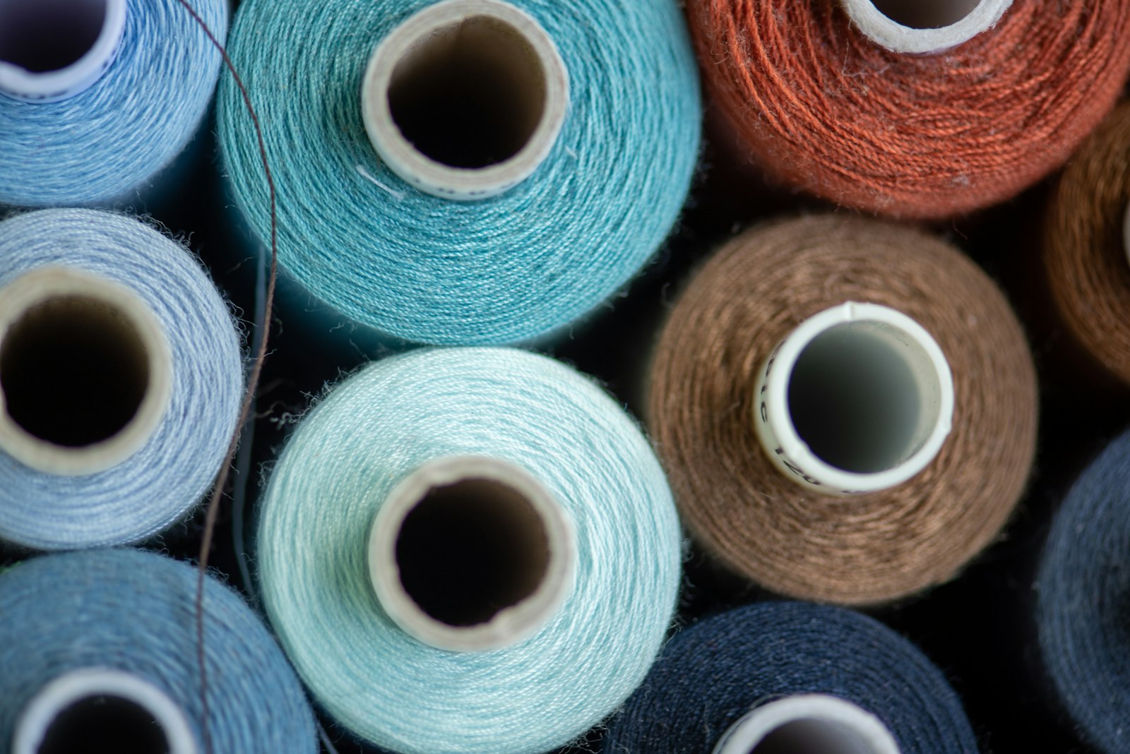 Fancy dyed yarn cones manufactured in Surat, assorted colours close-up