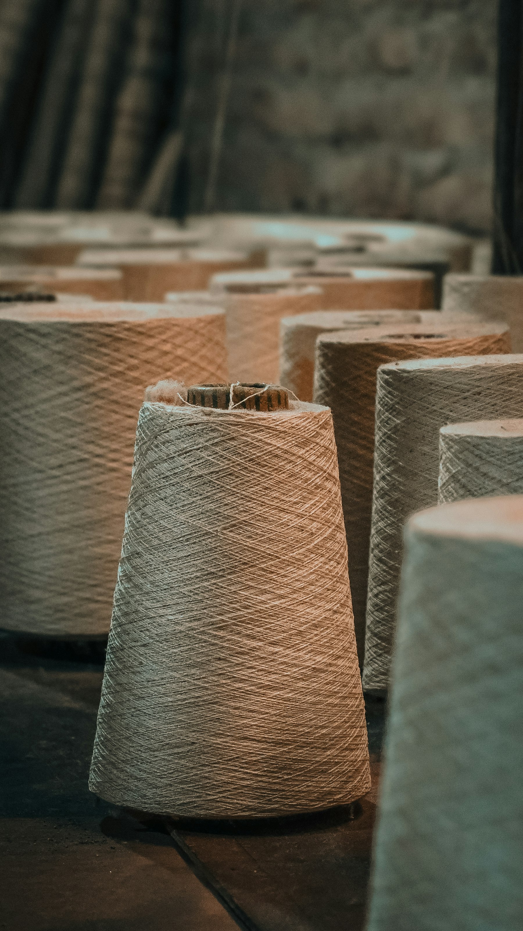 Spun yarn cones on the production floor at Royal Art Impex, Surat
